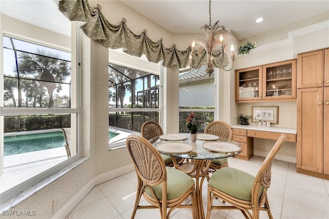 dining space with light tile patterned floors, an inviting chandelier, and a wealth of natural light