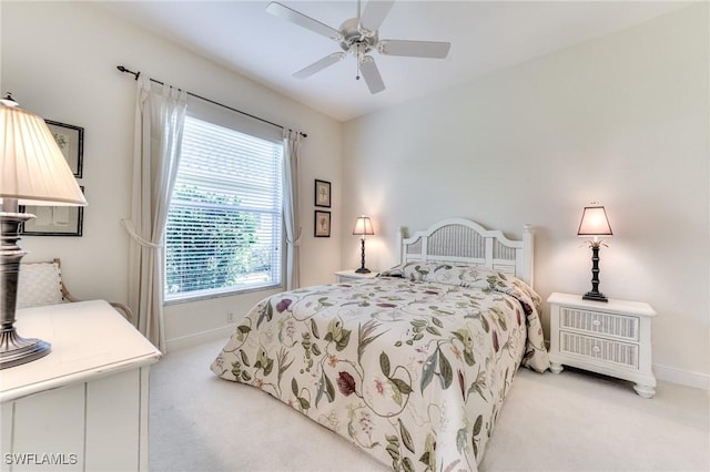 carpeted bedroom with ceiling fan and multiple windows