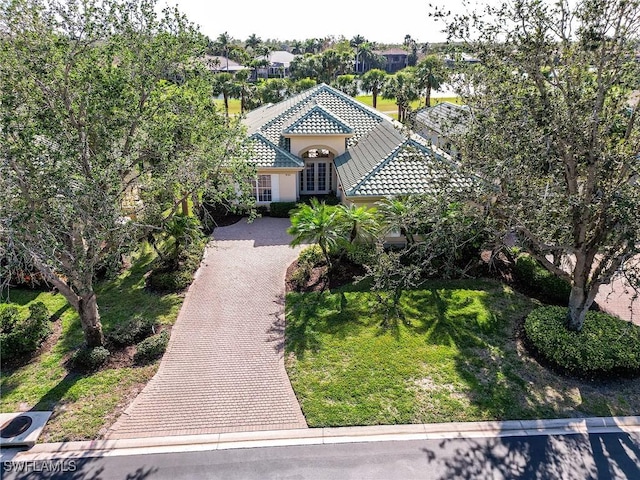 mediterranean / spanish home with a front lawn