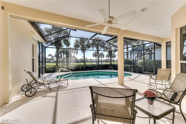 view of swimming pool featuring glass enclosure and a patio area