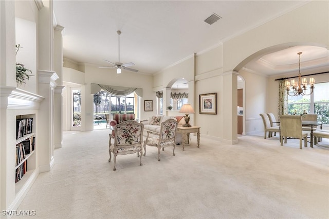 dining space featuring ceiling fan with notable chandelier, built in shelves, light colored carpet, and a towering ceiling