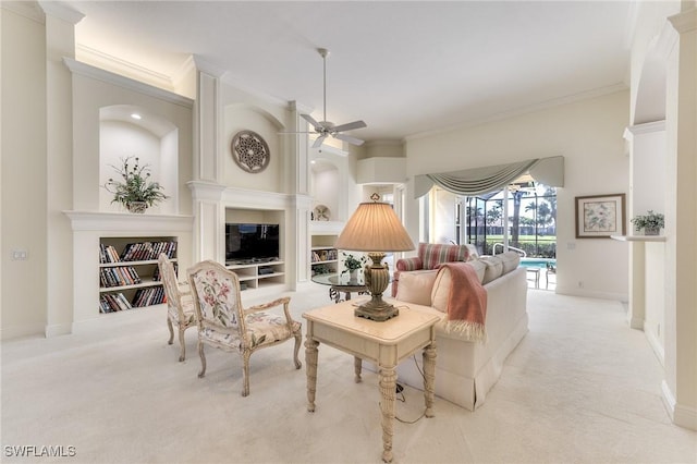 carpeted living room with ceiling fan and ornamental molding