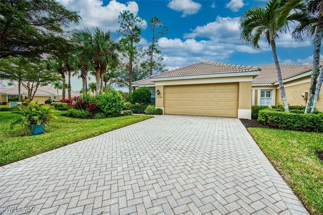 view of front of property featuring a garage and a front lawn