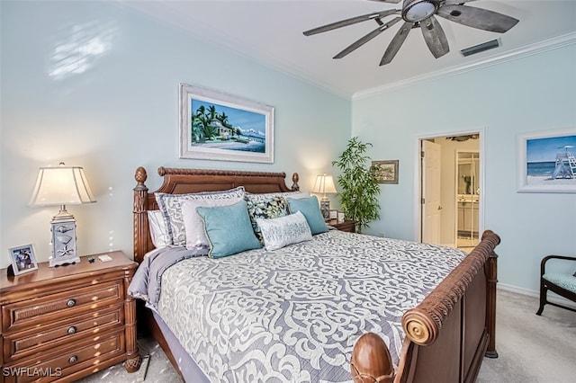 carpeted bedroom with ensuite bath, ceiling fan, and ornamental molding