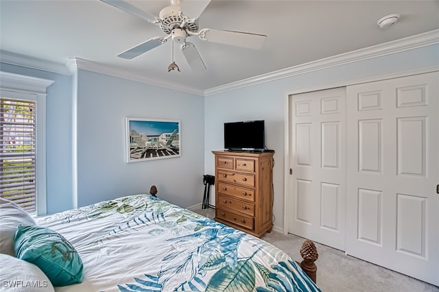 bedroom with ceiling fan, a closet, light carpet, and ornamental molding