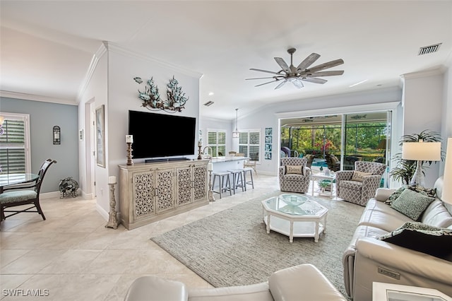 tiled living room with ceiling fan, ornamental molding, and lofted ceiling