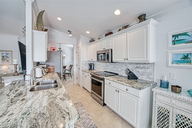 kitchen featuring sink, white cabinetry, appliances with stainless steel finishes, and crown molding