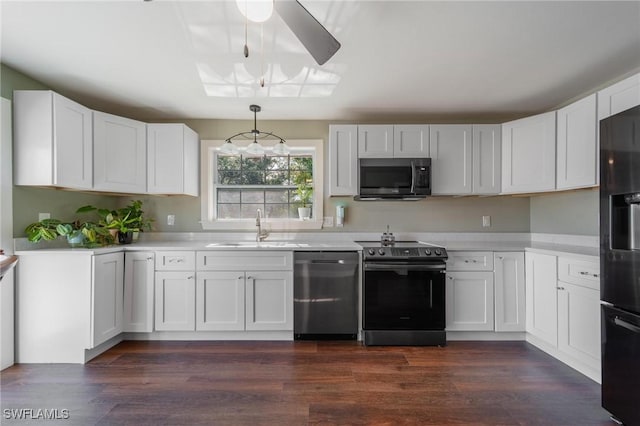 kitchen with sink, white cabinets, pendant lighting, and appliances with stainless steel finishes