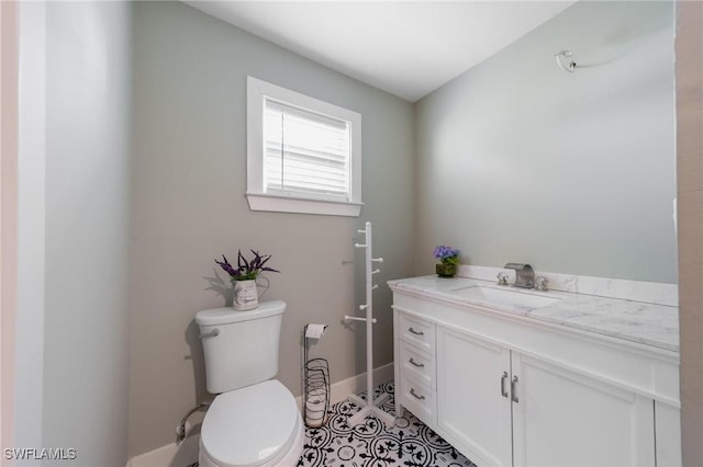 bathroom featuring tile patterned floors, vanity, and toilet