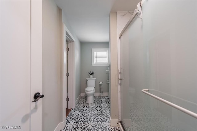 bathroom with an enclosed shower and toilet