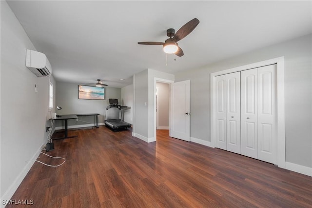 unfurnished office with a wall mounted air conditioner, dark hardwood / wood-style floors, and ceiling fan