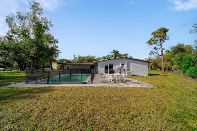 rear view of property featuring a yard and a patio