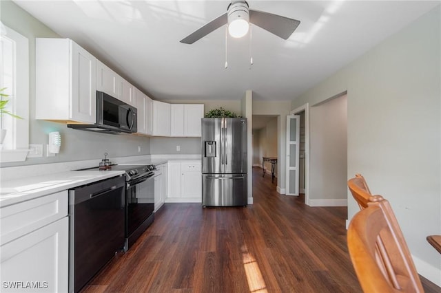 kitchen featuring stainless steel appliances, white cabinetry, and dark wood-type flooring