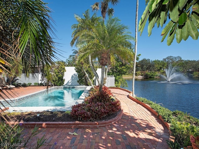 view of swimming pool featuring a water view