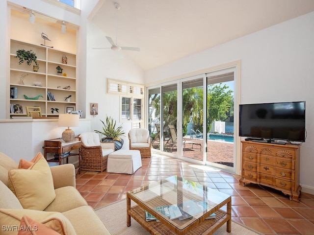 tiled living room with ceiling fan, high vaulted ceiling, built in features, and a healthy amount of sunlight