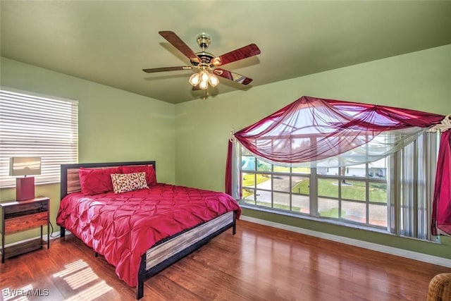 bedroom with hardwood / wood-style floors and ceiling fan