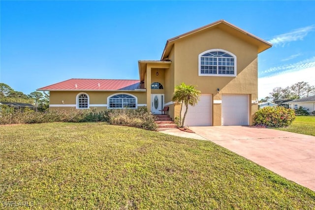 view of front of house with a garage and a front yard