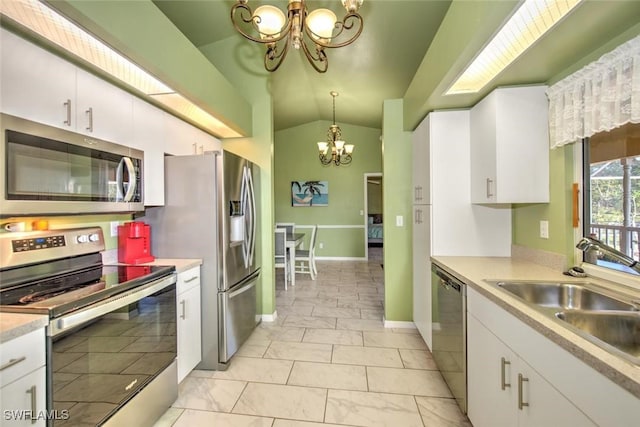 kitchen featuring sink, vaulted ceiling, a notable chandelier, stainless steel appliances, and white cabinets