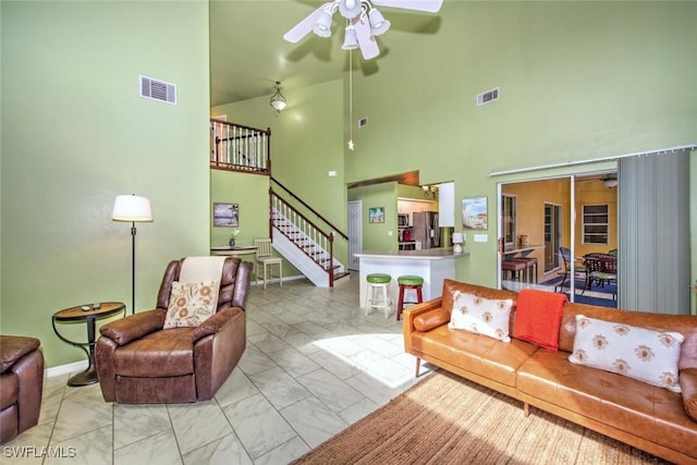 living room featuring a high ceiling and ceiling fan