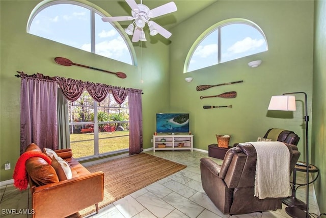 living room featuring high vaulted ceiling and ceiling fan