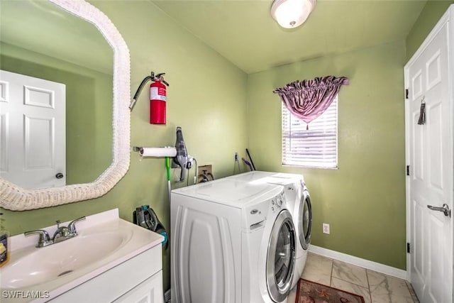 clothes washing area featuring separate washer and dryer and sink