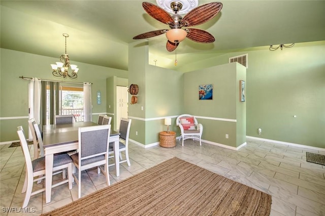 unfurnished dining area with ceiling fan with notable chandelier and vaulted ceiling