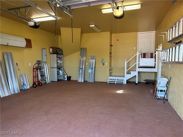 garage with a garage door opener and electric panel