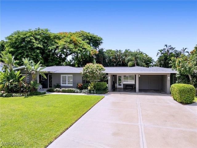 ranch-style home with a front yard and a carport