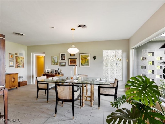 dining space featuring light tile patterned floors