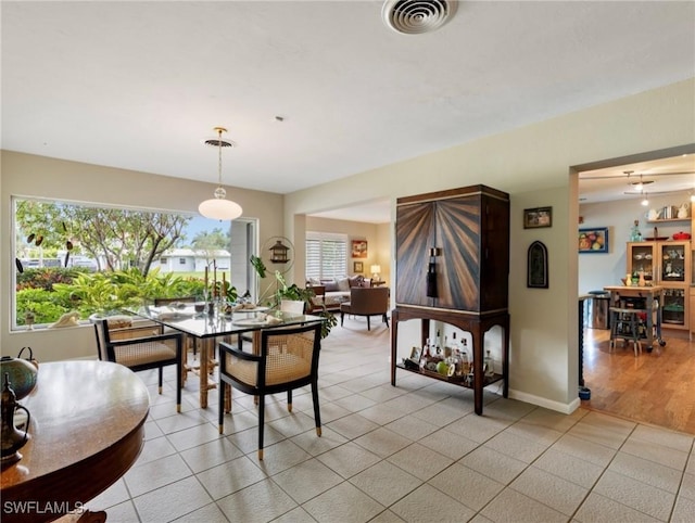 dining room featuring light tile patterned floors and plenty of natural light