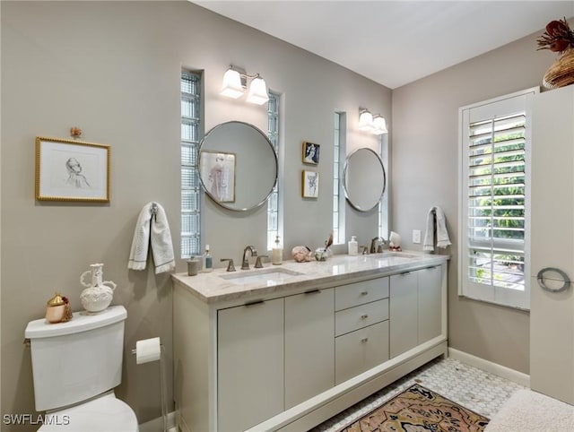 bathroom featuring tile patterned flooring, vanity, and toilet