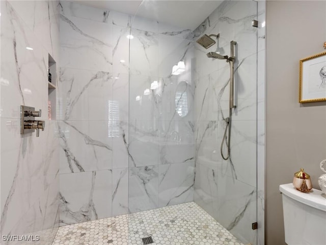 bathroom with tiled shower and toilet