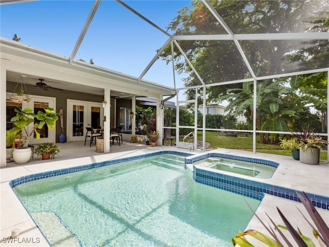 view of pool with a lanai, ceiling fan, an in ground hot tub, and a patio