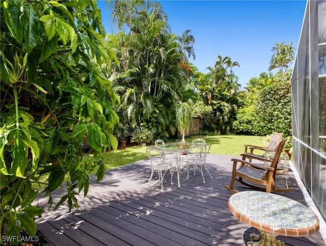 wooden terrace with a yard