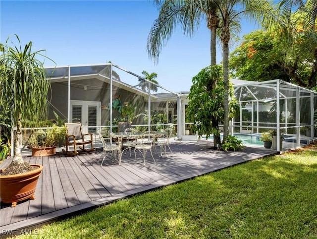 back of house with a yard, glass enclosure, and a swimming pool side deck