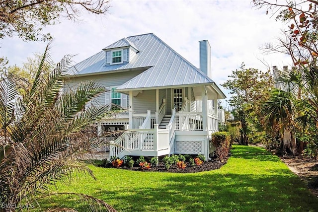 view of front of home featuring covered porch and a front yard