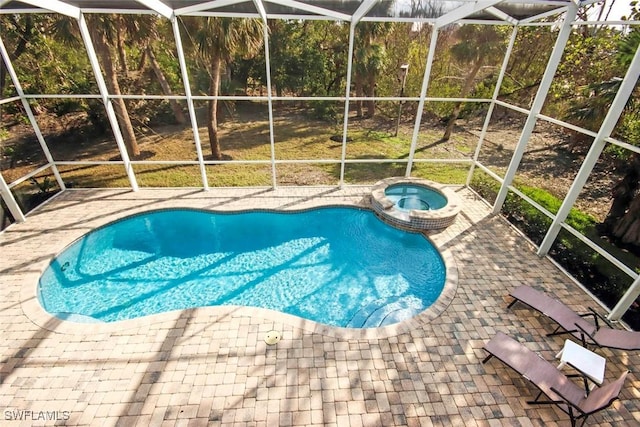 view of swimming pool with a lanai, an in ground hot tub, and a patio