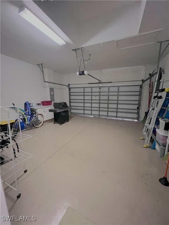 garage with a garage door opener and electric panel