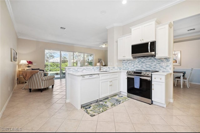 kitchen featuring white cabinetry, tasteful backsplash, stainless steel appliances, and kitchen peninsula