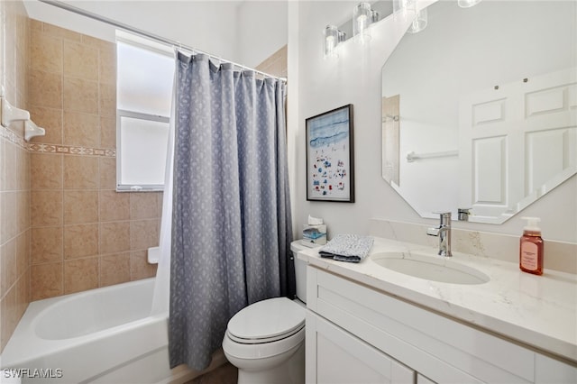 full bathroom featuring shower / bath combo, vanity, and toilet