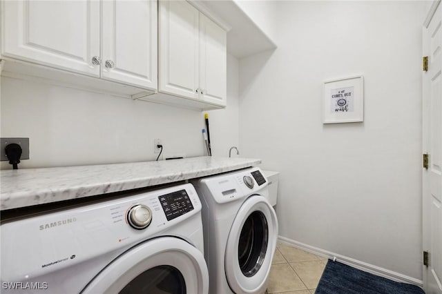 washroom featuring cabinets, separate washer and dryer, and light tile patterned floors