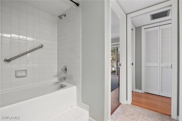 bathroom featuring tile patterned flooring and tiled shower / bath combo