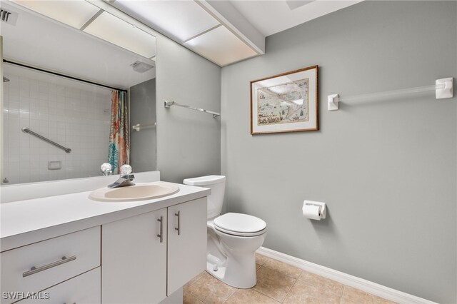 bathroom featuring a shower with curtain, tile patterned flooring, vanity, and toilet