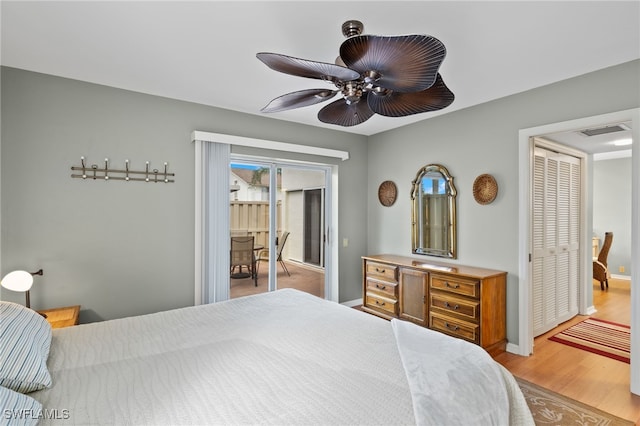 bedroom featuring ceiling fan, light hardwood / wood-style floors, access to outside, and a closet