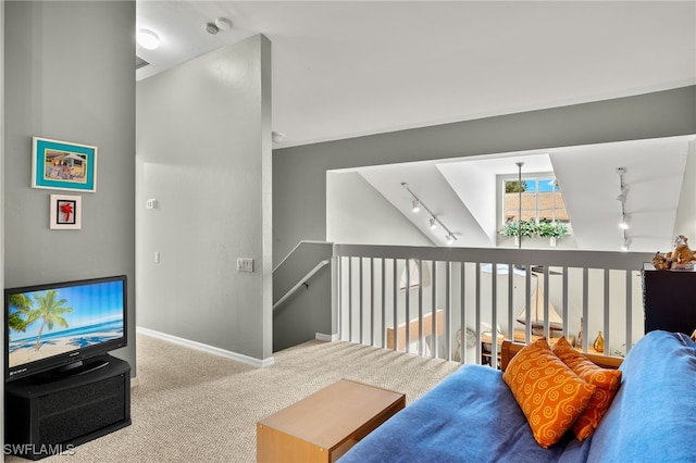 carpeted living room featuring track lighting