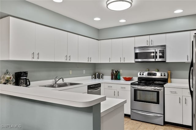 kitchen featuring white cabinetry, kitchen peninsula, and appliances with stainless steel finishes