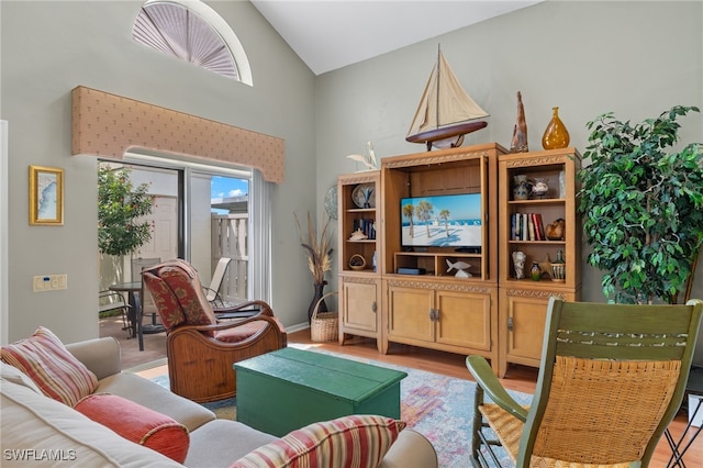 living room featuring light hardwood / wood-style floors and high vaulted ceiling