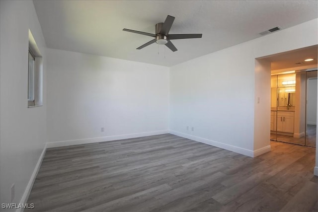 unfurnished room featuring ceiling fan and dark hardwood / wood-style floors