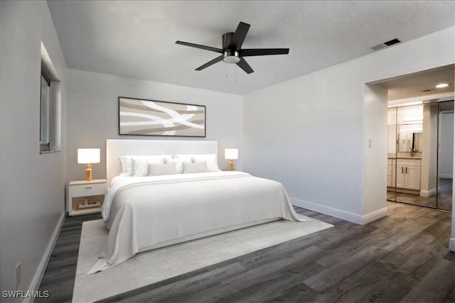 bedroom featuring ceiling fan, dark hardwood / wood-style flooring, and a textured ceiling