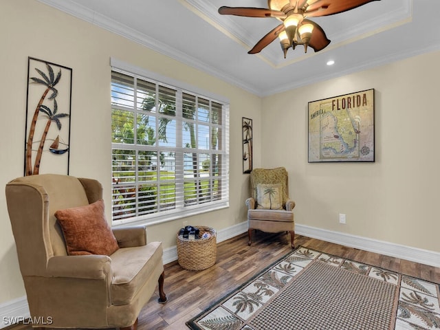 living area featuring crown molding, wood-type flooring, and a wealth of natural light